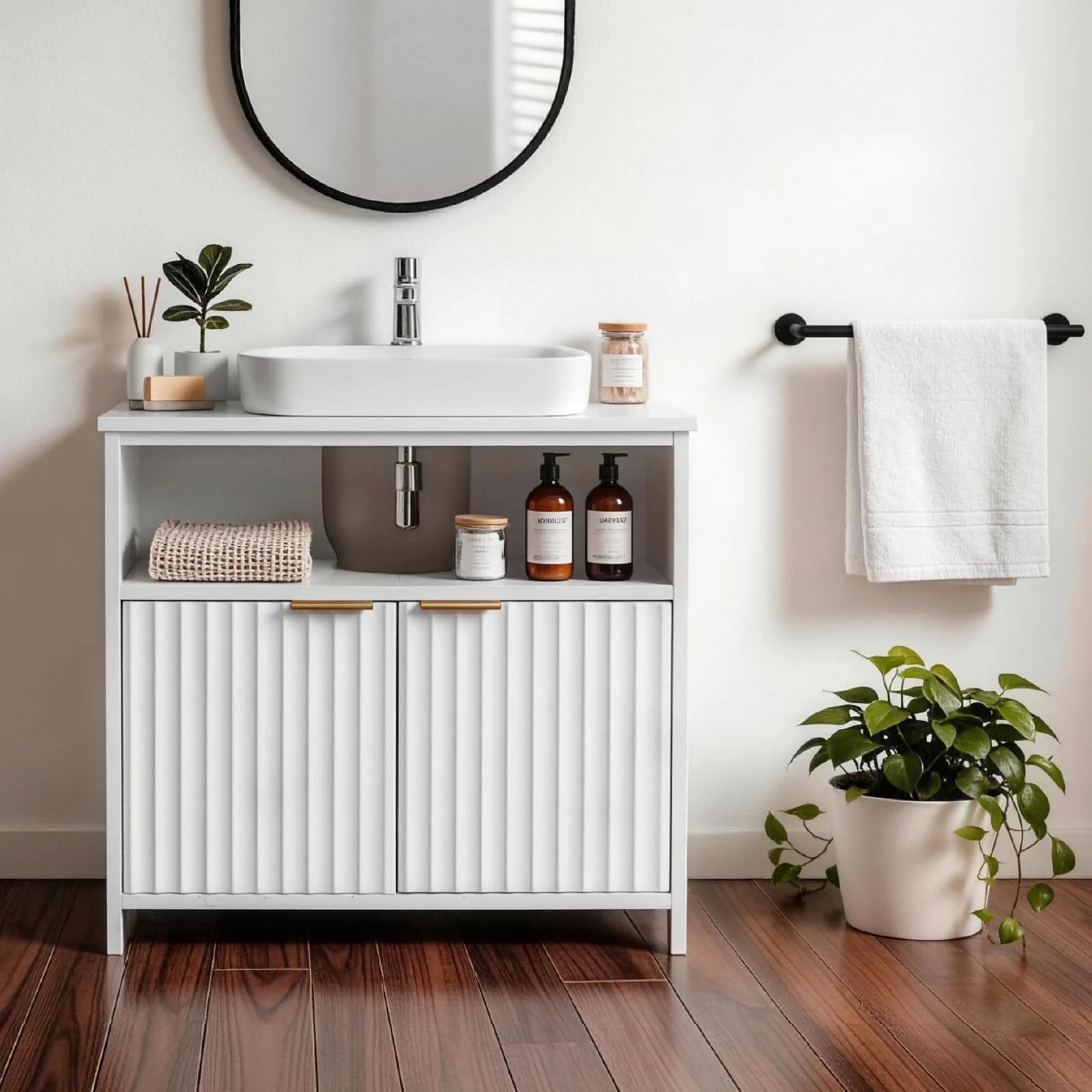 An under-sink cabinet with a fluted front, cut around the pipes of a small bathroom.